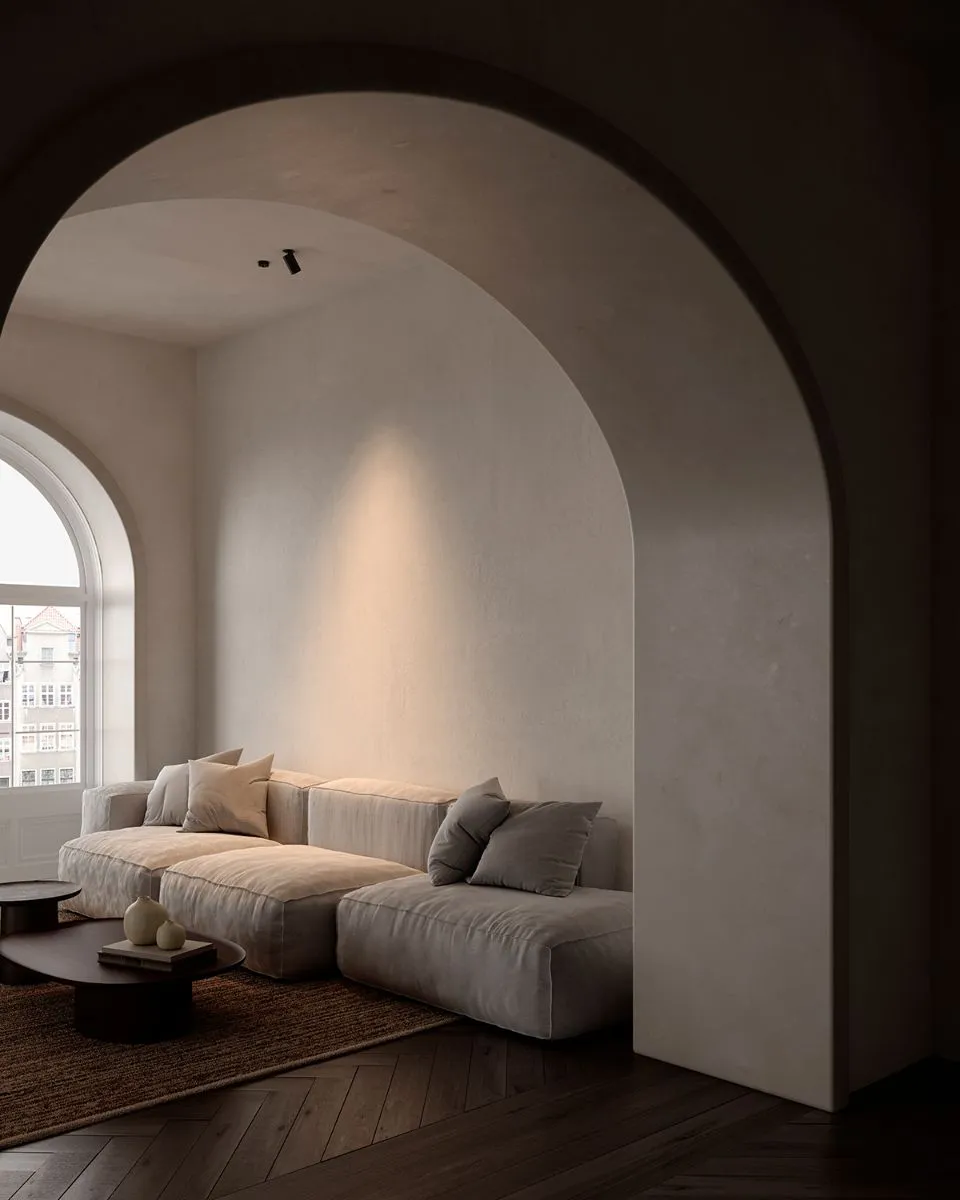 A cozy modern living room featuring a stylish couch and an art piece elegantly displayed on the wall.