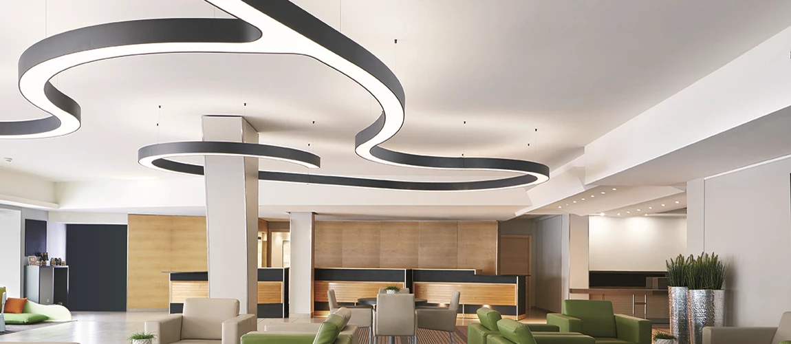 Modern lobby with stylish wavy ceiling design, neutral tones, and plush seating.